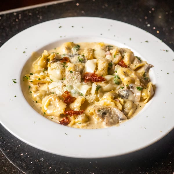 Sapore Italian Cafe's tortellini pasta with creamy sauce, sun-dried tomatoes, and mushrooms.
